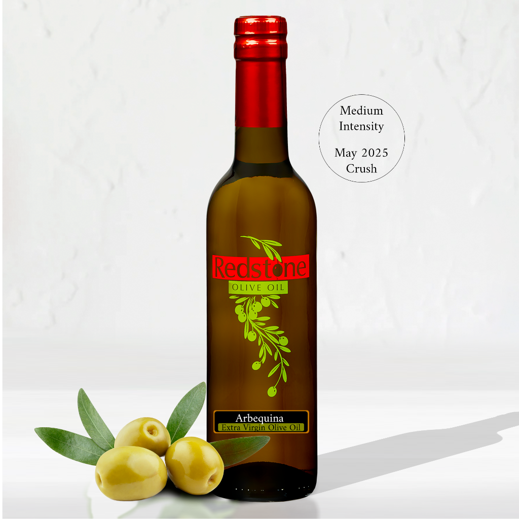 Bottle of Arbequina Extra virgin olive oil with fresh olives