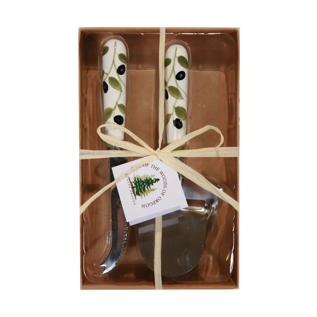 Gift-wrapped cheese knife set with olive motif ceramic handles in a brown box.