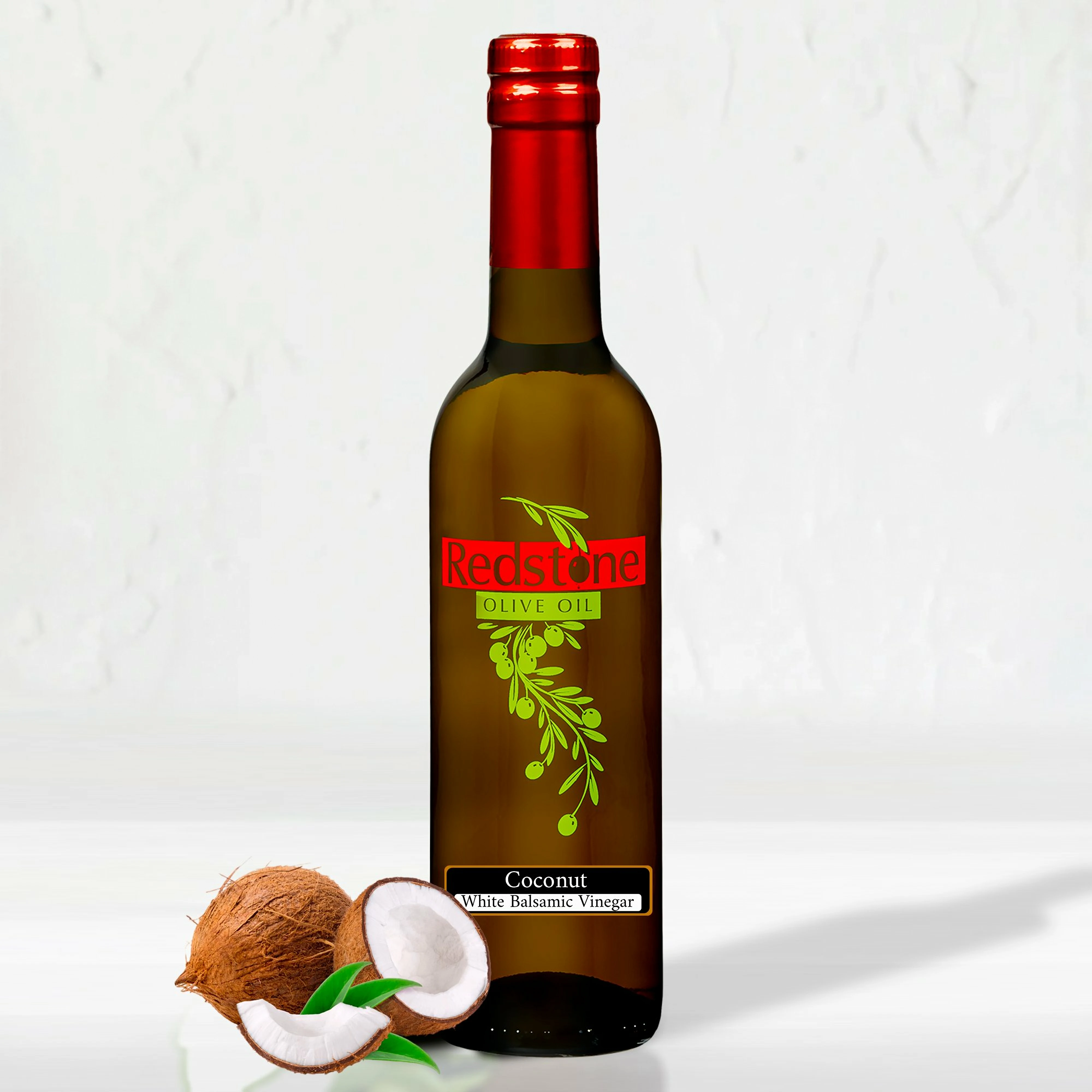 Coconut White Balsamic Vinegar bottle with a fresh coconut beside it