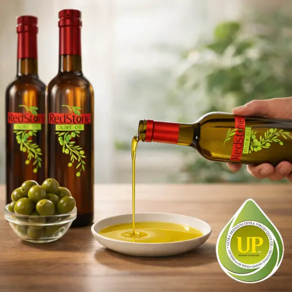 Two bottles of extra virgin olive oil and pouring into a bowl