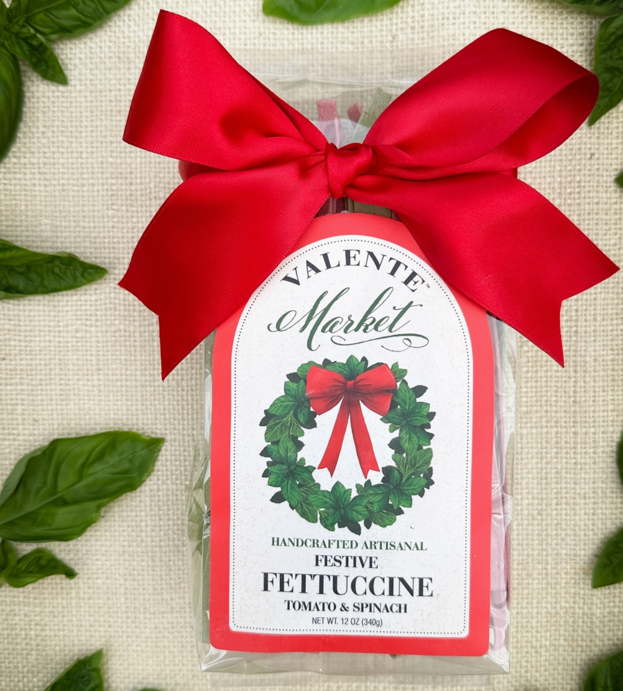 Festive Fettuccine with basil and tomato with a red bow