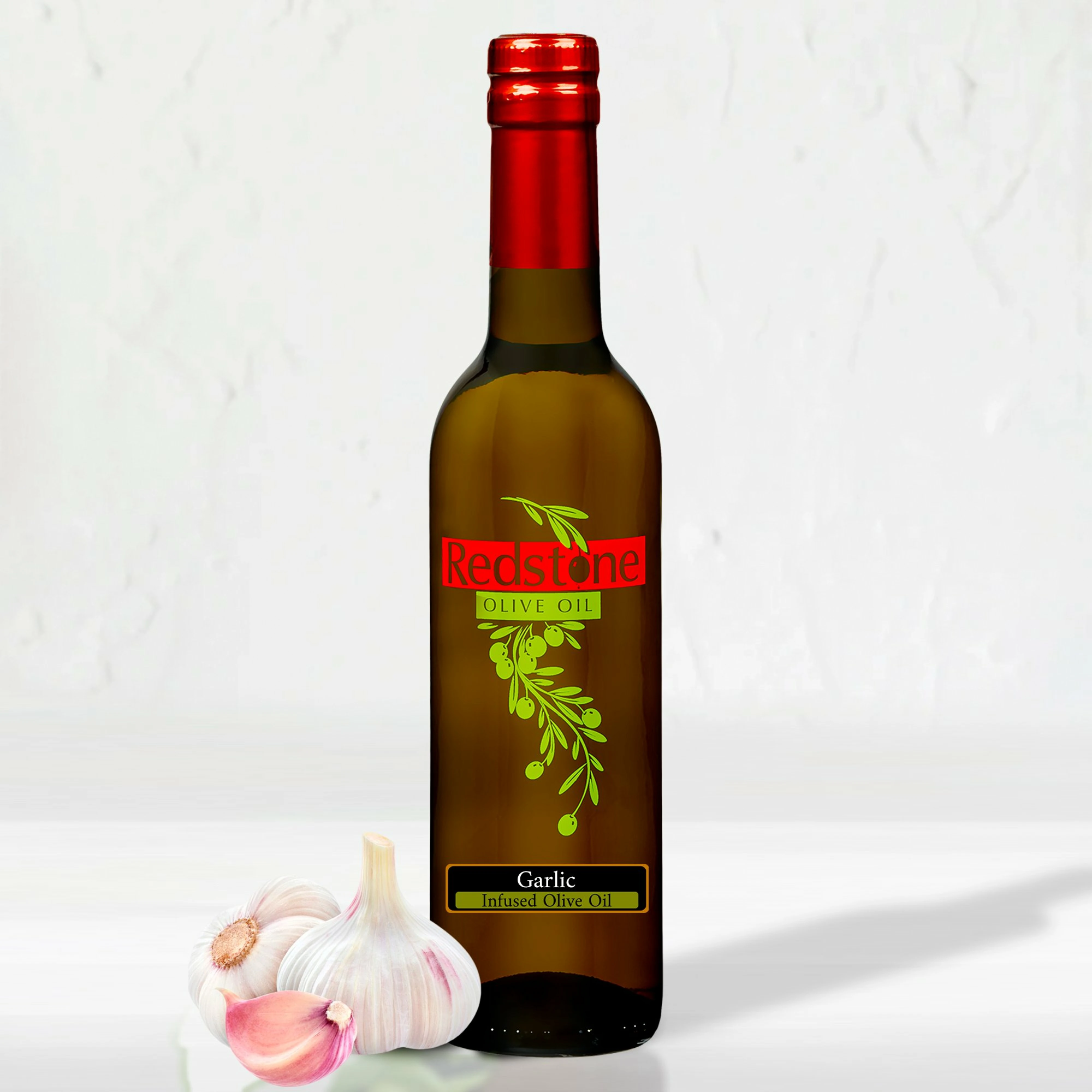 A bottle of Garlic Infused Olive Oil with a garlic clove beside it