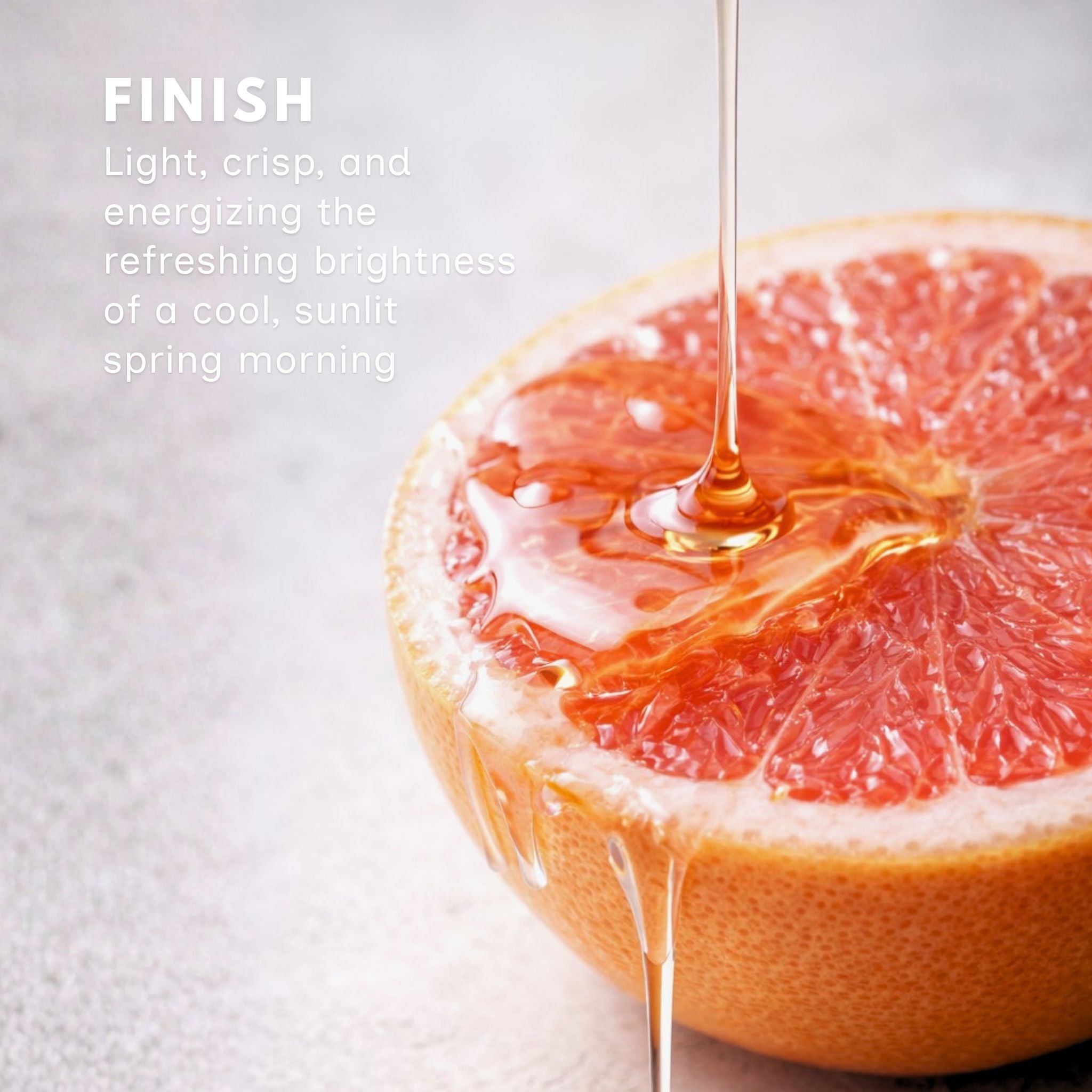 Grapefruit balsamic vinegar drizzled over half a fresh grapefruit on a light background