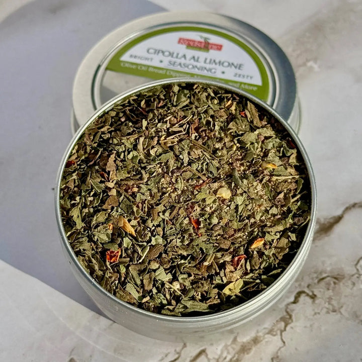 Cipolla al Limone seasoning blend in a round tin on a light stone surface