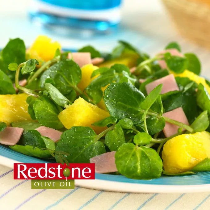 Mango citrus salad and marinade on a blue plate with Redstone Olive Oil branding.