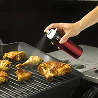 Thumbnail for Misto oil sprayer in use for seasoning chicken on a grill