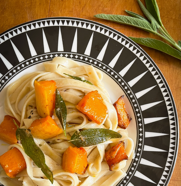 Pumpkin Fettuccini in bowl with pumpkn chunks and sage