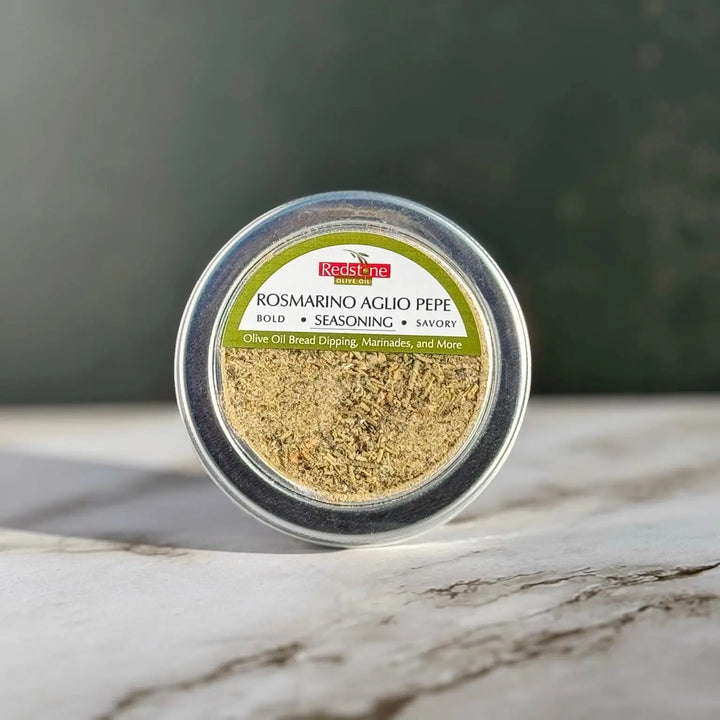 Rosmarino Aglio Pepe seasoning blend tin for olive oil bread dipping and marinades on marble surface