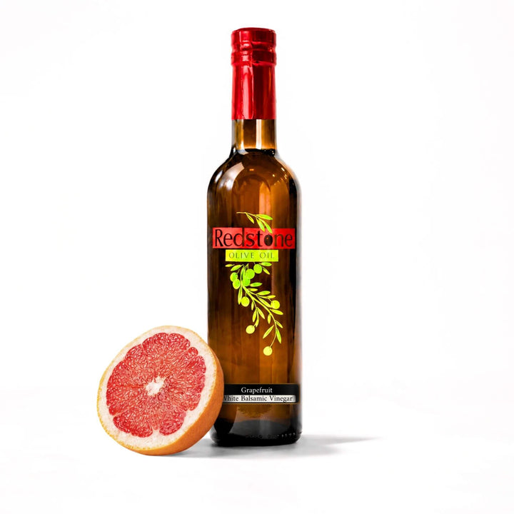 Redstone Olive Oil Grapefruit White Balsamic Vinegar 375ml bottle with halved ruby red grapefruit on white background