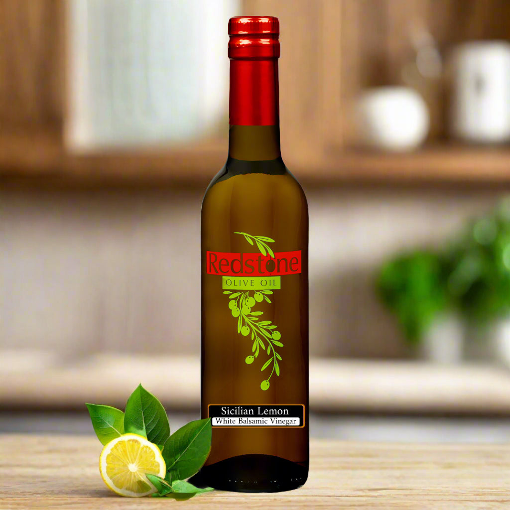 Close-up of Sicilian Lemon Balsamic Vinegar bottle in kitchen with lemons in the background