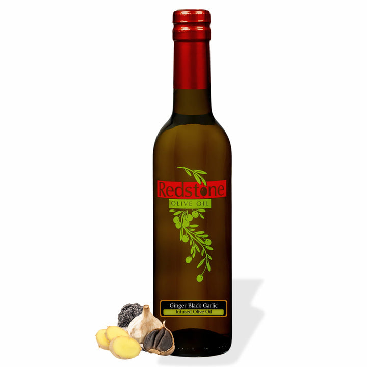 Bottle of Redstone Ginger Black Garlic Infused Olive Oil with fresh ginger and black garlic