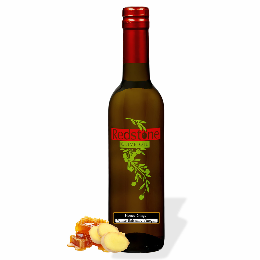 Bottle of Redstone Honey Ginger White Balsamic Vinegar with honeycomb and sliced fresh ginger