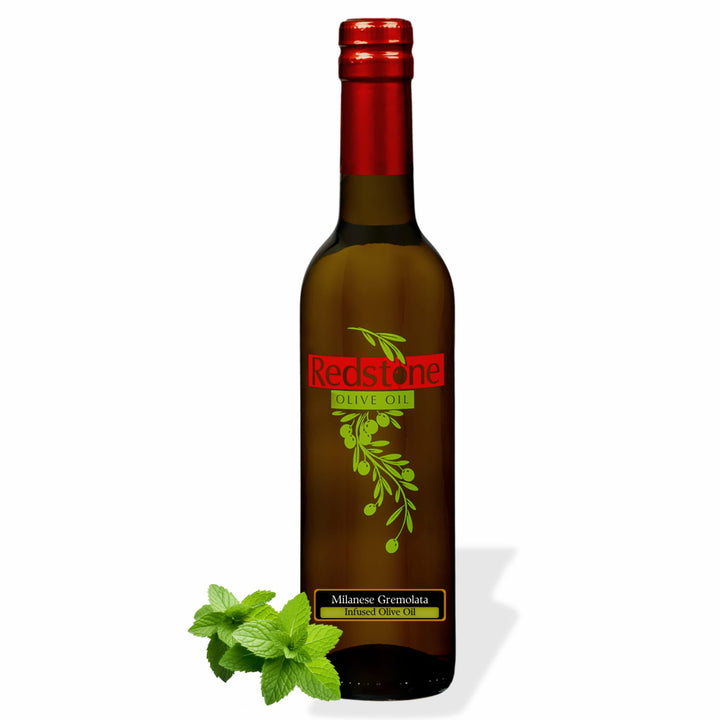 Bottle of Redstone Milanese Gremolata Infused Olive Oil with fresh mint leaves