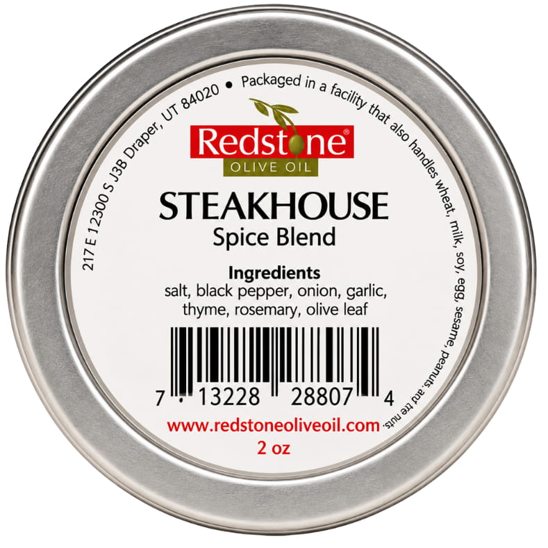 Redstone Steakhouse Spice Blend back label showing barcode, ingredients: salt, black pepper, onion, garlic, thyme, rosemary, olive leaf — 2 oz tin